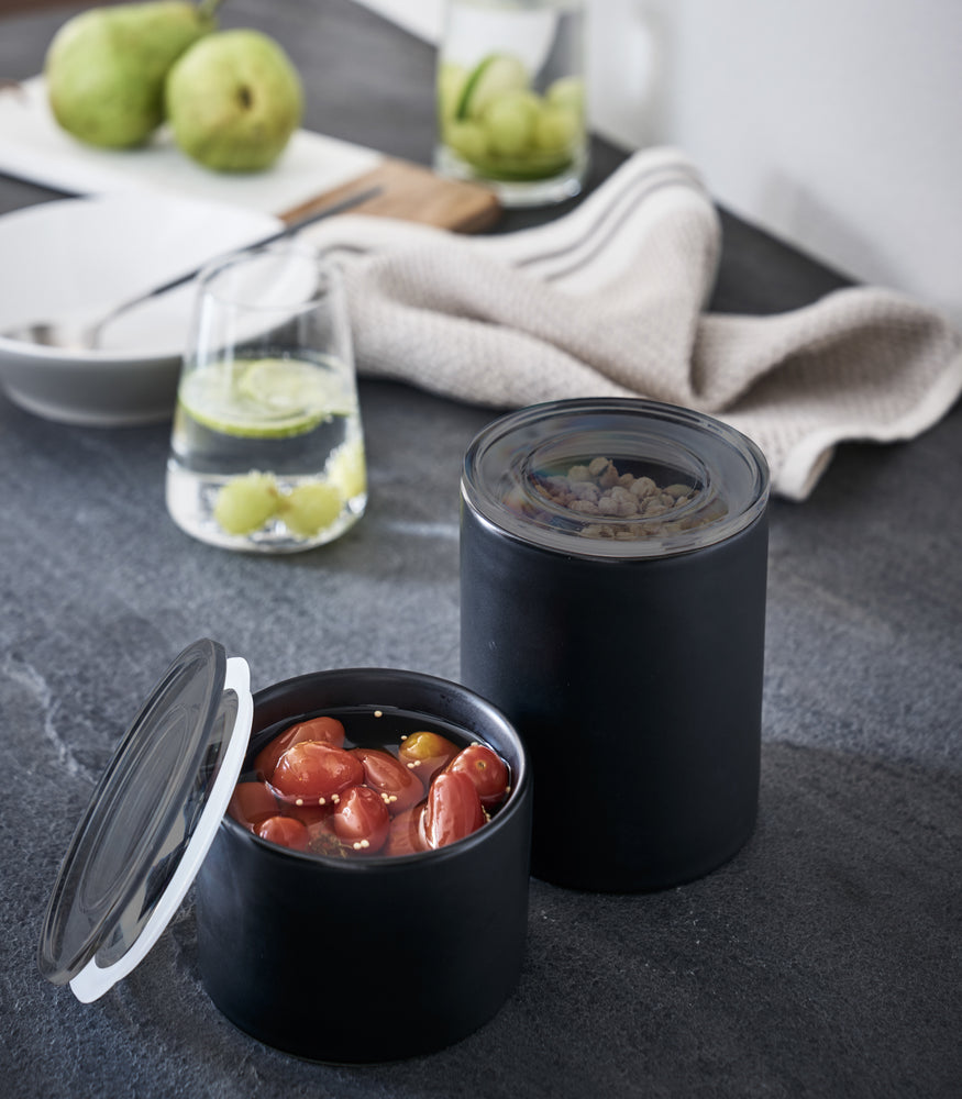 View 7 - Close up view of black Ceramic Canisters holding food items on kitchen counter by Yamazaki Home.