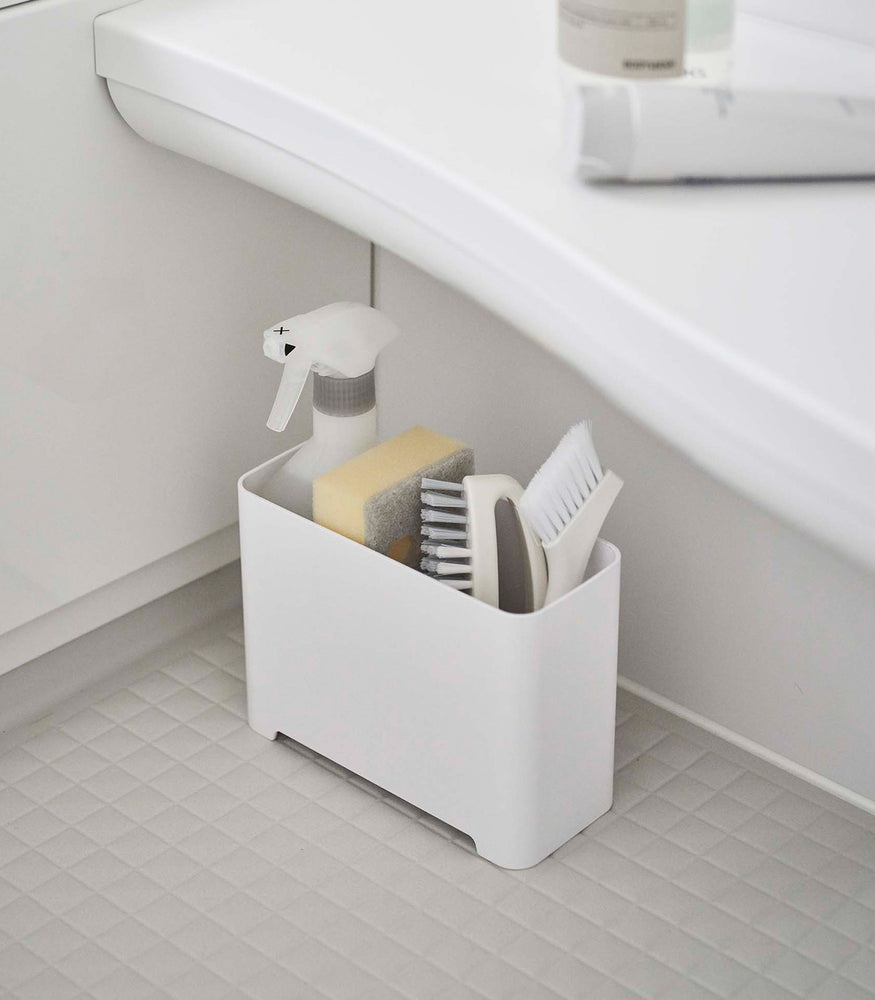 View 4 - White Yamazaki Self-Draining Bathroom Organizer filled with cleaning supplies