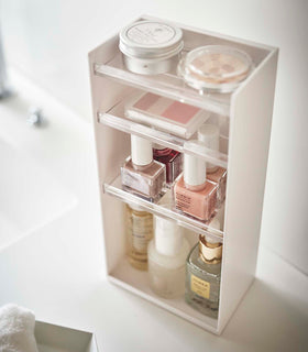 White Cosmetics Storage Tower by Yamazaki Home holding nail polish and other cosmetic items. view 20