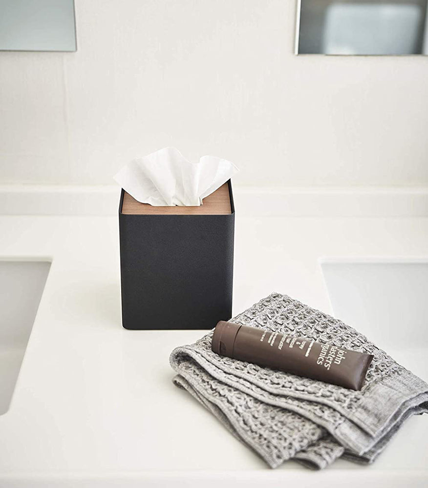 View 12 - Front view of black Tissue Case on bathroom countertop by Yamazaki Home.