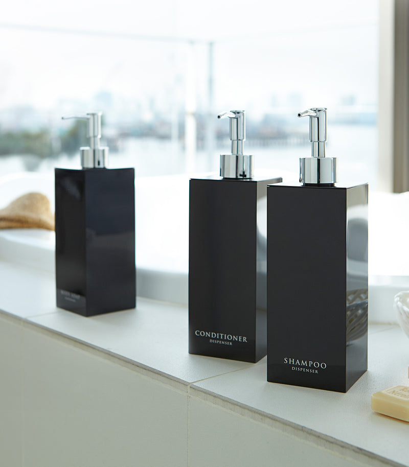 Black Yamazaki Home square soap dispenser in three styles by bathtub