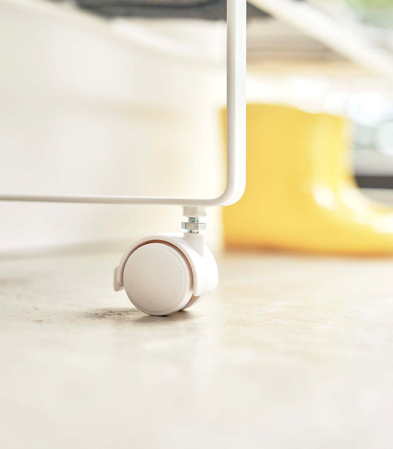 Close up view of wheels used on white Yamazaki Entryway Organizer