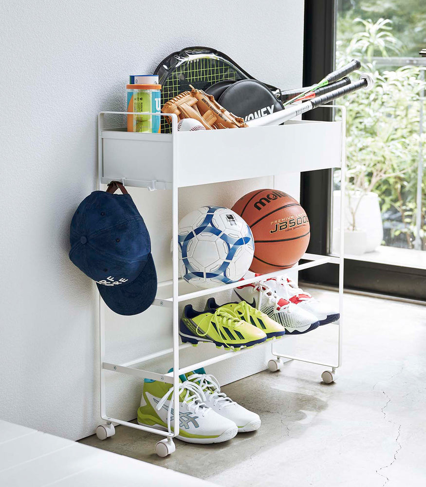 View 4 - White Yamazaki Entryway Organizer with shoes and sports equipment on it