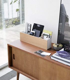 White Desk Organizer holding office items on tv stand by Yamazaki Home. view 11