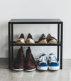 Front view of Black Shoe Organizer holding shoes by Yamazaki Home.
