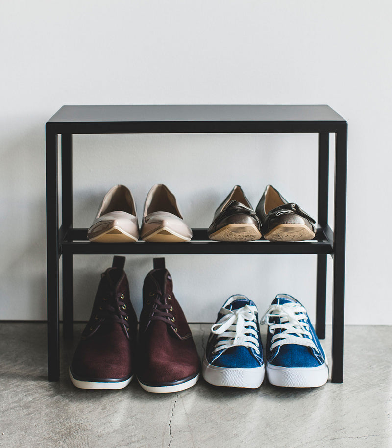 Front view of Black Shoe Organizer holding shoes by Yamazaki Home.