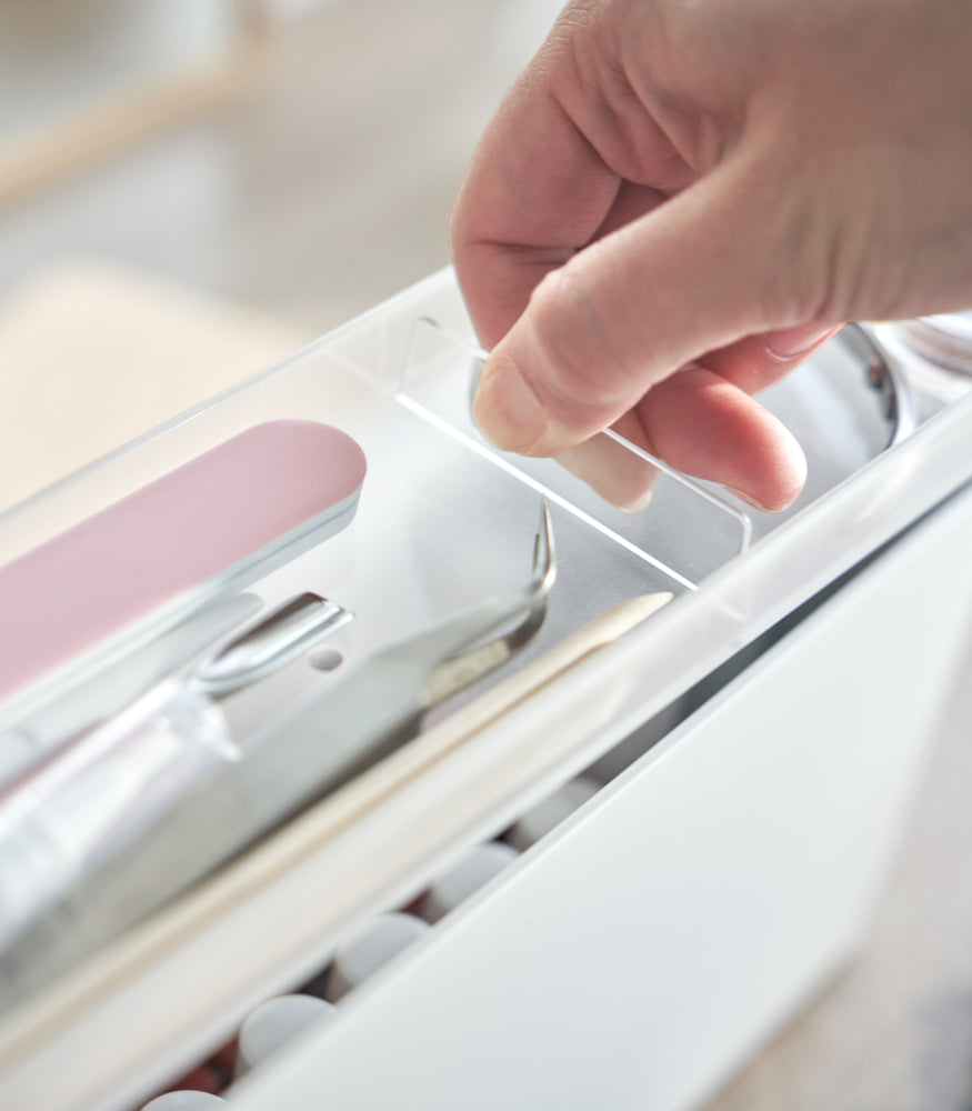 View 8 - An open Yamazaki Nail Polish Organizer's transparent tray being removed.