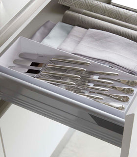 White Cutlery Storage Organizer holding silverware in kitchen drawer by Yamazaki Home. view 2