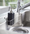 Side view of black Hand Soap Dispenser in kitchen sink by Yamazaki Home.