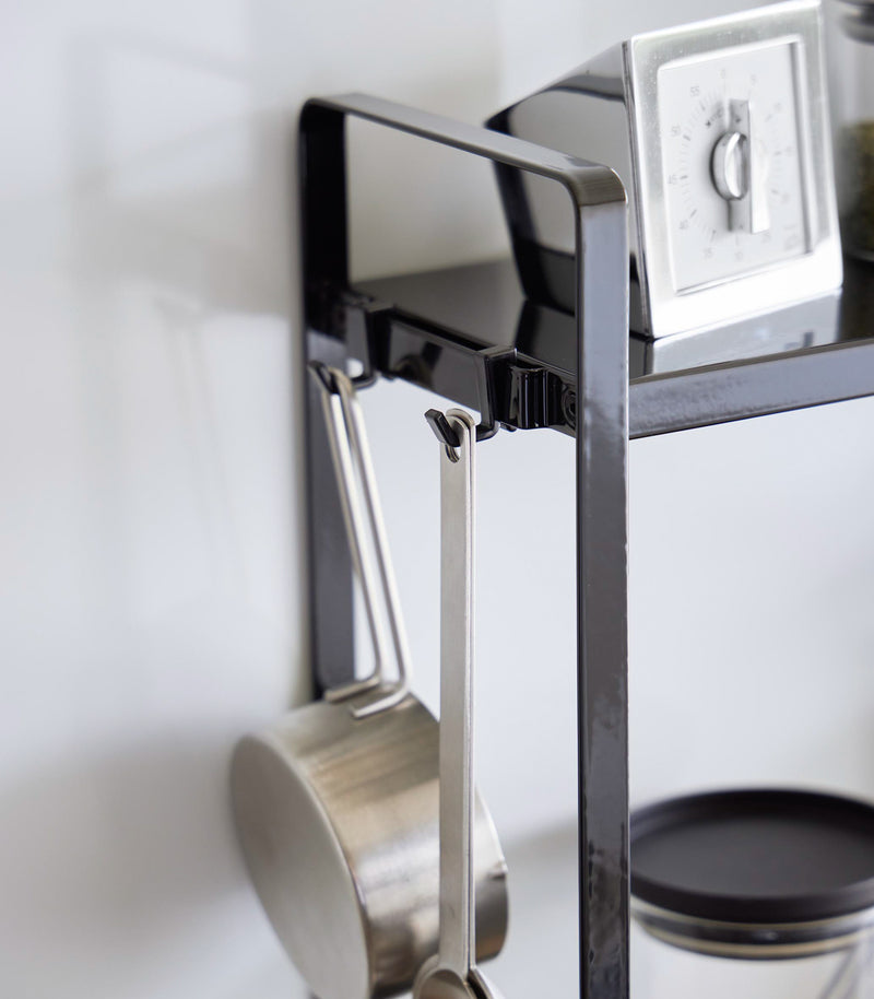 Close up view of hooks of Yamazaki Home Two-Tier Countertop Rack.