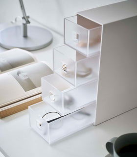 Close up of white Yamazaki Home Storage Tower with Drawers opened and filled with accessories view 6