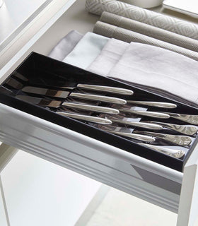 Black Cutlery Storage Organizer holding silverware in kitchen drawer by Yamazaki Home. view 9
