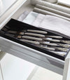 Black Cutlery Storage Organizer holding silverware in kitchen drawer by Yamazaki Home.