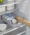 Yamazaki Refrigerator Organizer Bin with a person reaching for a can inside the bin