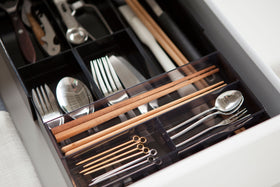 Close up aerial view of black Expandable Drawer Organizer holding utensils by Yamazaki Home. view 25