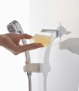 Taking out soap from white Yamazaki Home Magnetic Soap Holder view 5