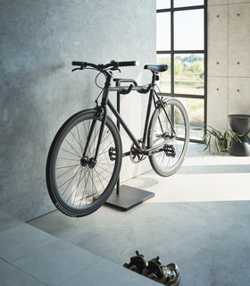 Yamazaki Home Bicycle Stand in an entryway storing a bicycle view 3