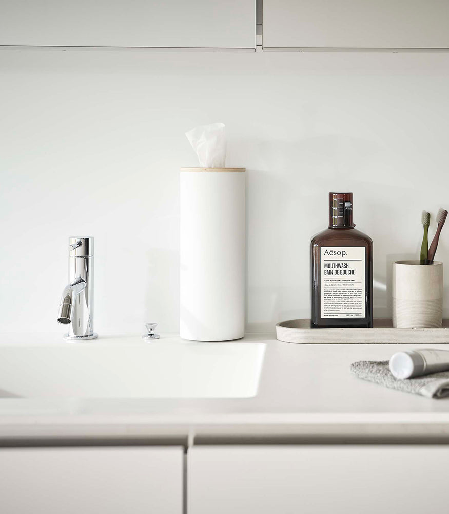 View 25 - Large White Yamazaki Home Round Tissue Case on a bathroom sink counter