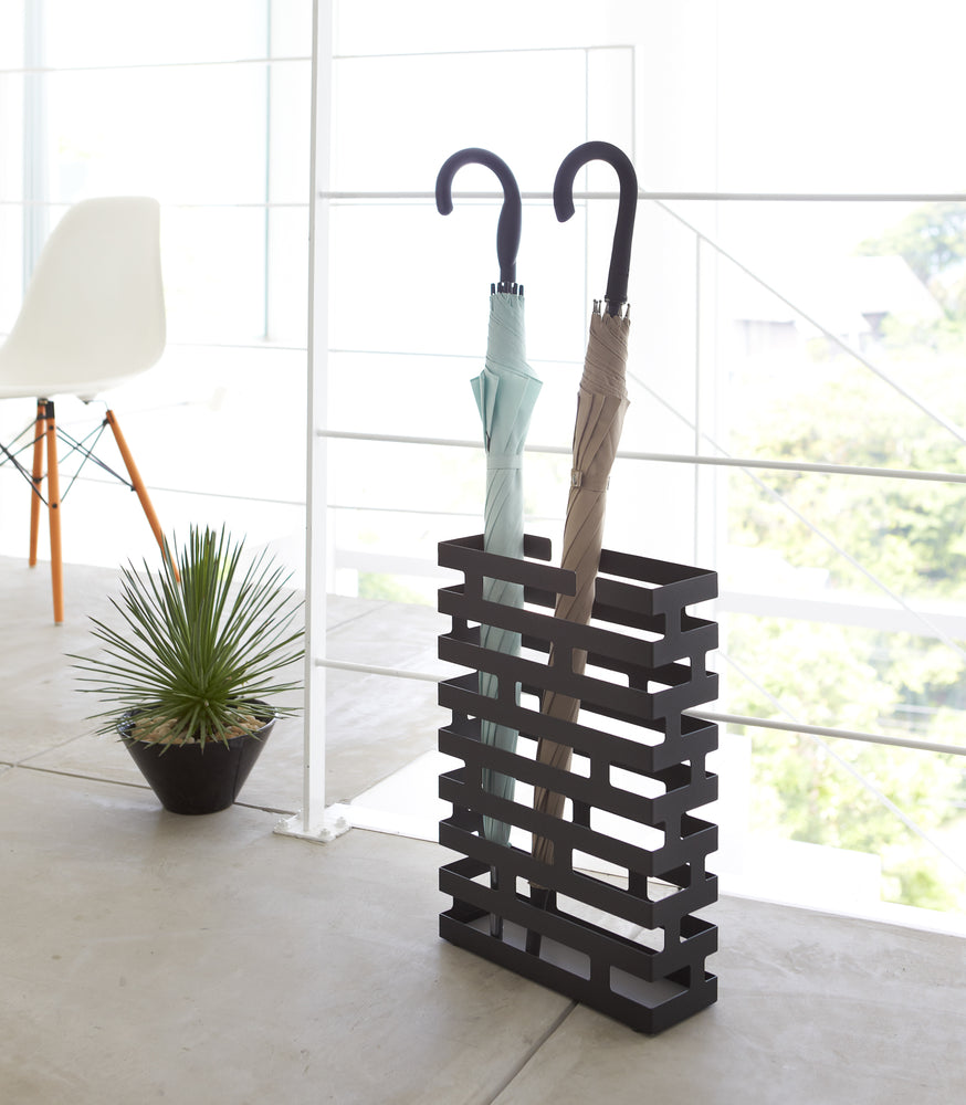 View 18 - Black Shoe Rack in entryway holding heels and sneakers by Yamazaki home.