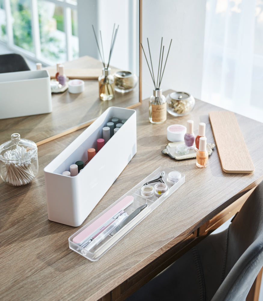 View 4 - A Yamazaki Nail Polish Organizer with its tray removed sitting on a table.