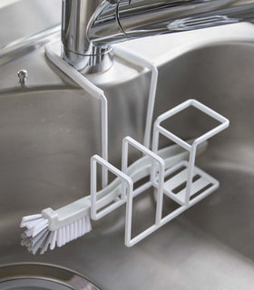 White Steel Yamazaki Home Faucet-Hanging Sponge & Brush Holder holding a brush view 8