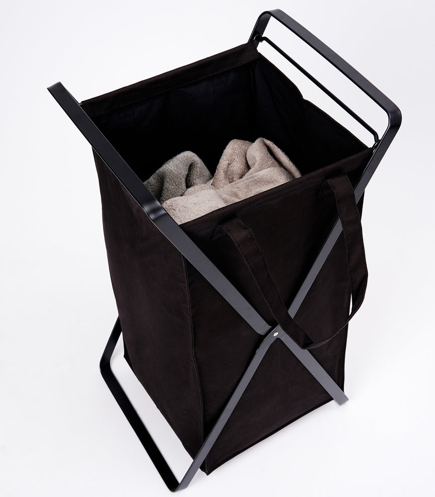 View 9 - Small Laundry Hamper with Cotton Liner by Yamazaki Home in black on a white background with towels inside.