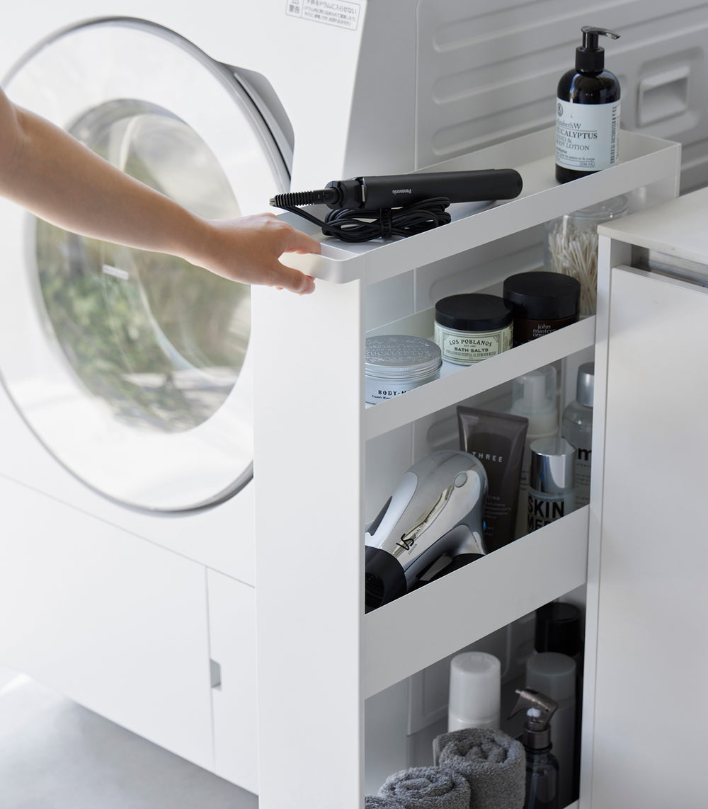 White Yamazaki Home Slim Rolling Cart holding hair products in a tight corner