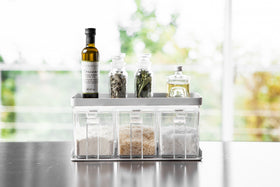 Front view of white Pantry Organizer holding spices and ingredients on upper shelf by Yamazaki Home. view 5