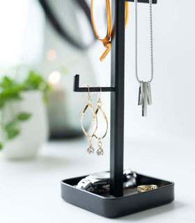 Close up of black Yamazaki Home Tree Accessory Stand displaying earrings view 16