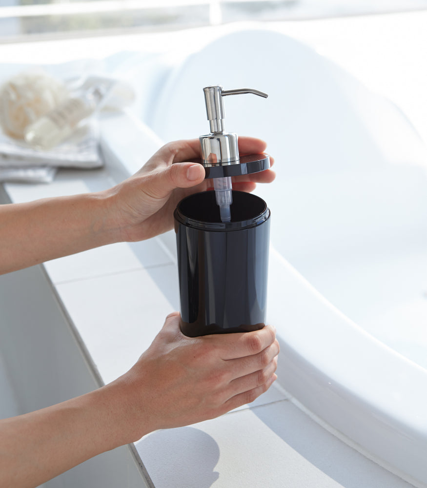 View 31 - Black Body Soap Dispenser with top off in bathroom by Yamazaki Home.