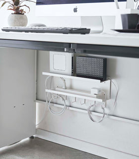 White Wall-Mount Cable and Router Storage Rack holding routers and power cord under desk by Yamazaki Home. view 3
