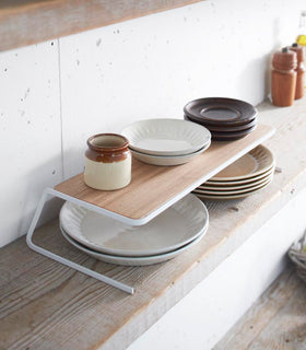 Plate Riser holding plates on shelf by Yamazaki Home. view 10