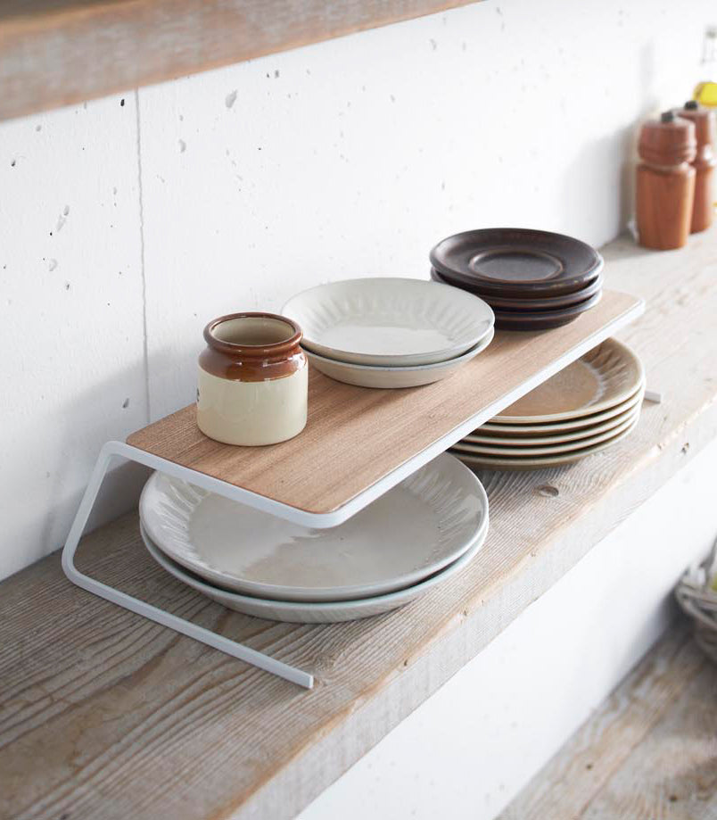 View 10 - Plate Riser holding plates on shelf by Yamazaki Home.