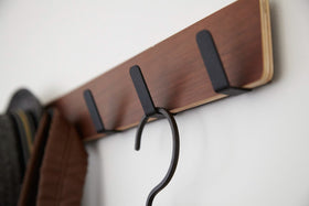 Close up view of Over-the-Door Hanger holding hat and hanger by Yamazaki Home. view 8