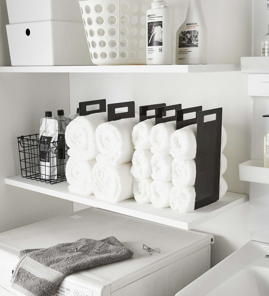 View 8 - Black Towel Storage Organziers holding towels on laundry room shelf by Yamazaki Home.
