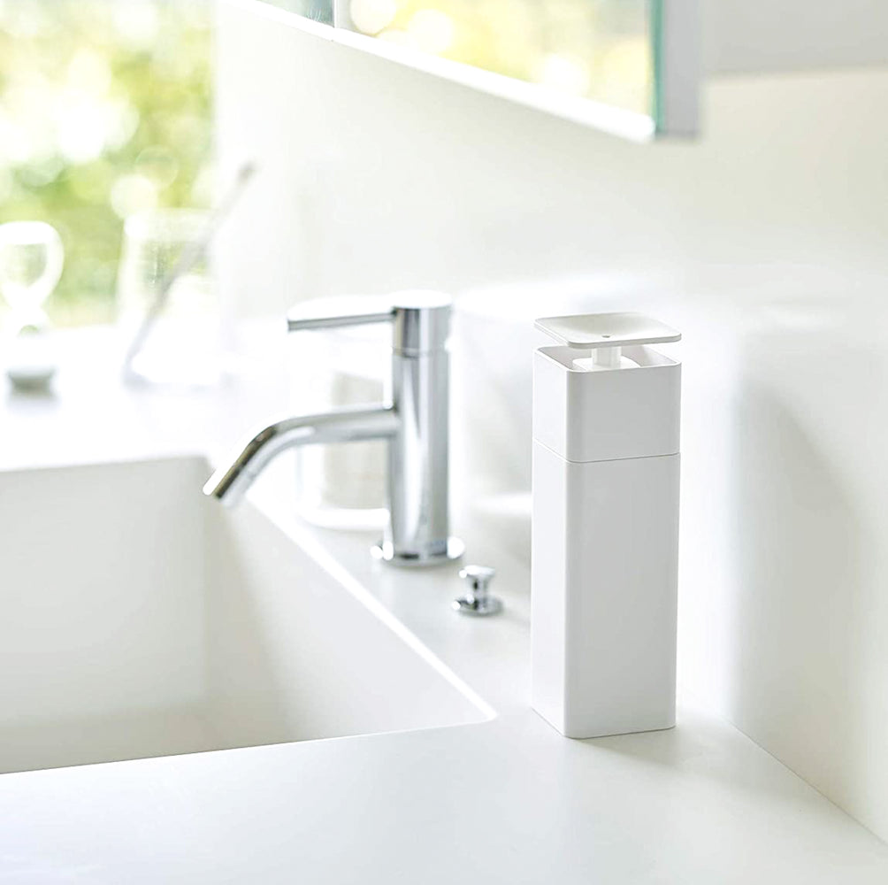 View 3 - White One-Handed Push Soap Dispenser on bathroom sink counter by Yamazaki Home.