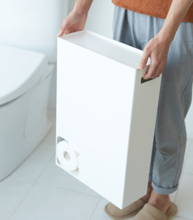 Front view of white Toilet Paper Stocker carried by handles in bathroom by Yamazaki Home. view 6