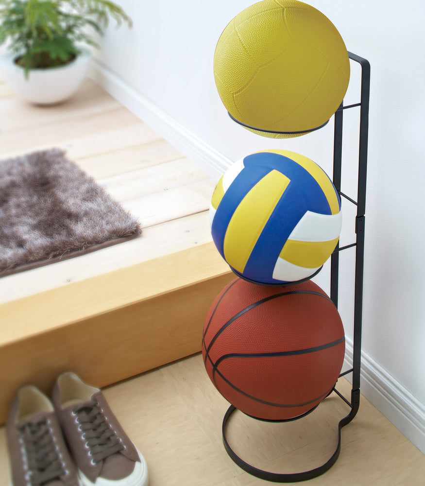 View 3 - Black Sport Ball Stand displaying sport balls in entryway by Yamazaki Home.