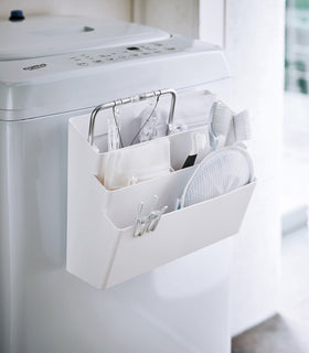 White Magnetic Storage Caddy holding cleaning items in laundry room by Yamazaki Home. view 2