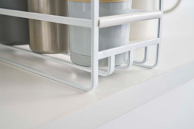 Close up of the grating of a Yamazaki Home white Glass and Mug Cabinet Organizer view 7