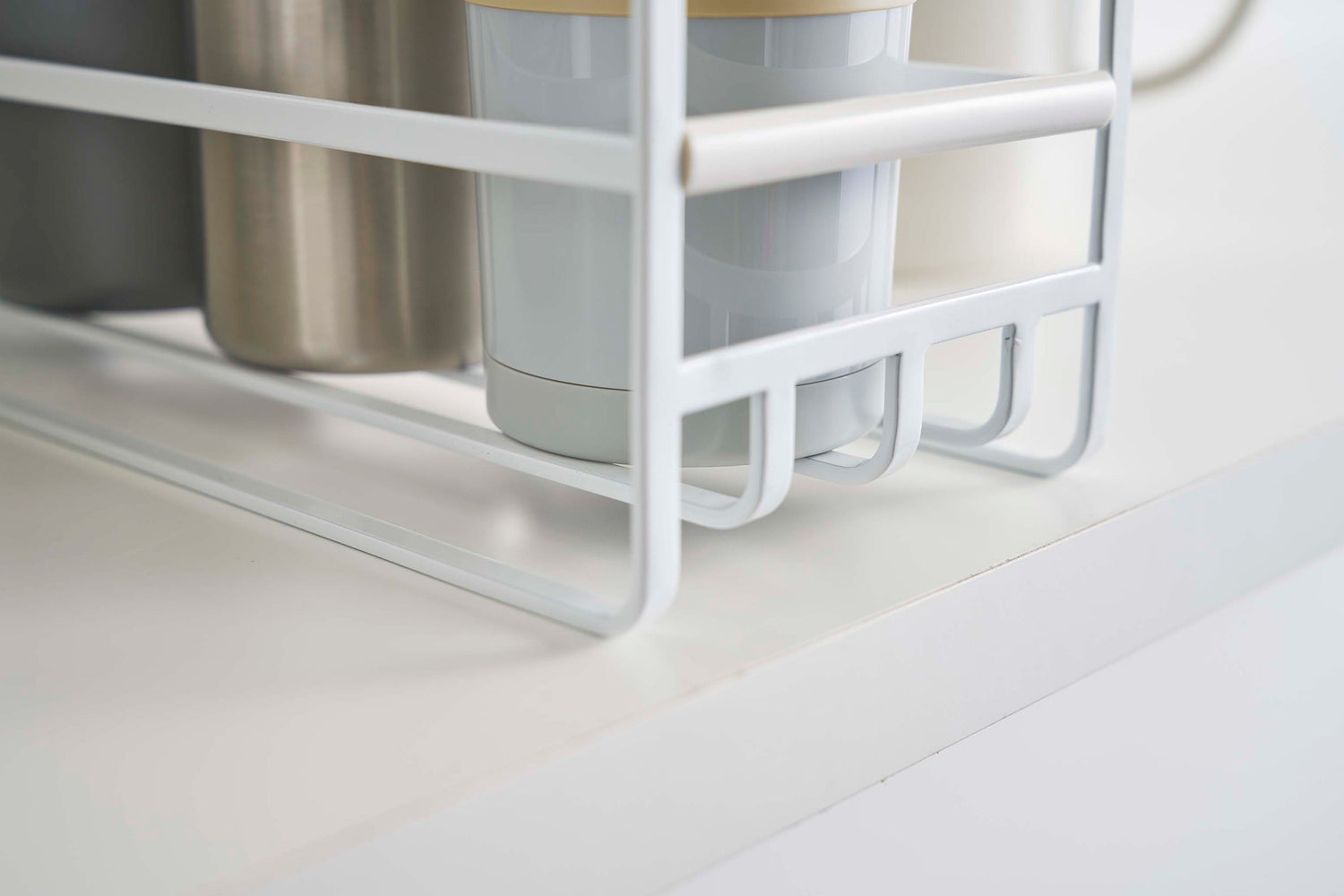 View 7 - Close up of the grating of a Yamazaki Home white Glass and Mug Cabinet Organizer