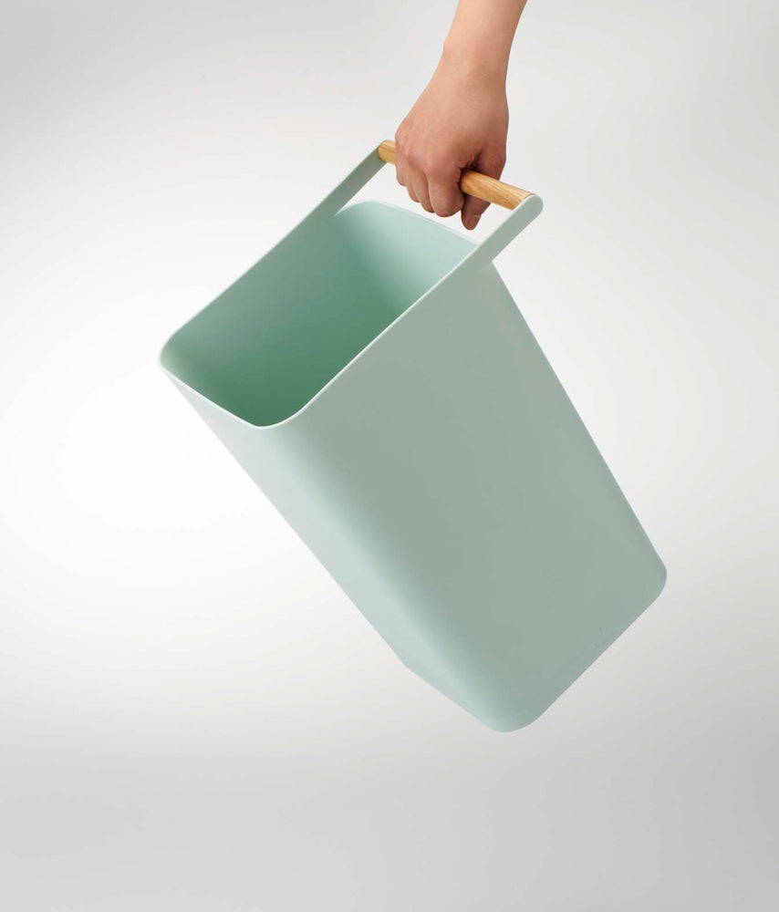 View 9 - Blue Trash Can held by handle on white background by Yamazaki Home.