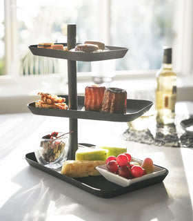 Front view of black Serving Standing dispalying desserts on table by Yamazaki Home. view 7