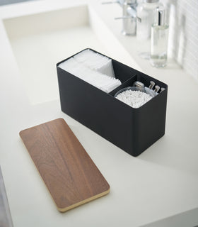 Black Countertop Organizer holding bathroom items with lid off on sink countertop by Yamazaki Home. view 14