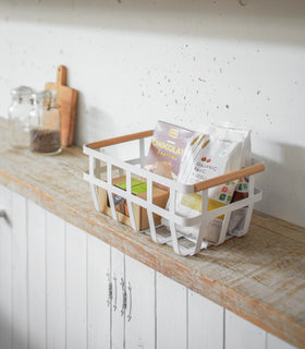 White storage basket holding food items on shelf by Yamazaki Home. view 7