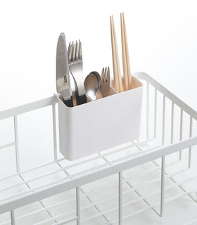 Close up view of white Dish Rack utensil organizer holding utensils by Yamazaki Home. view 5