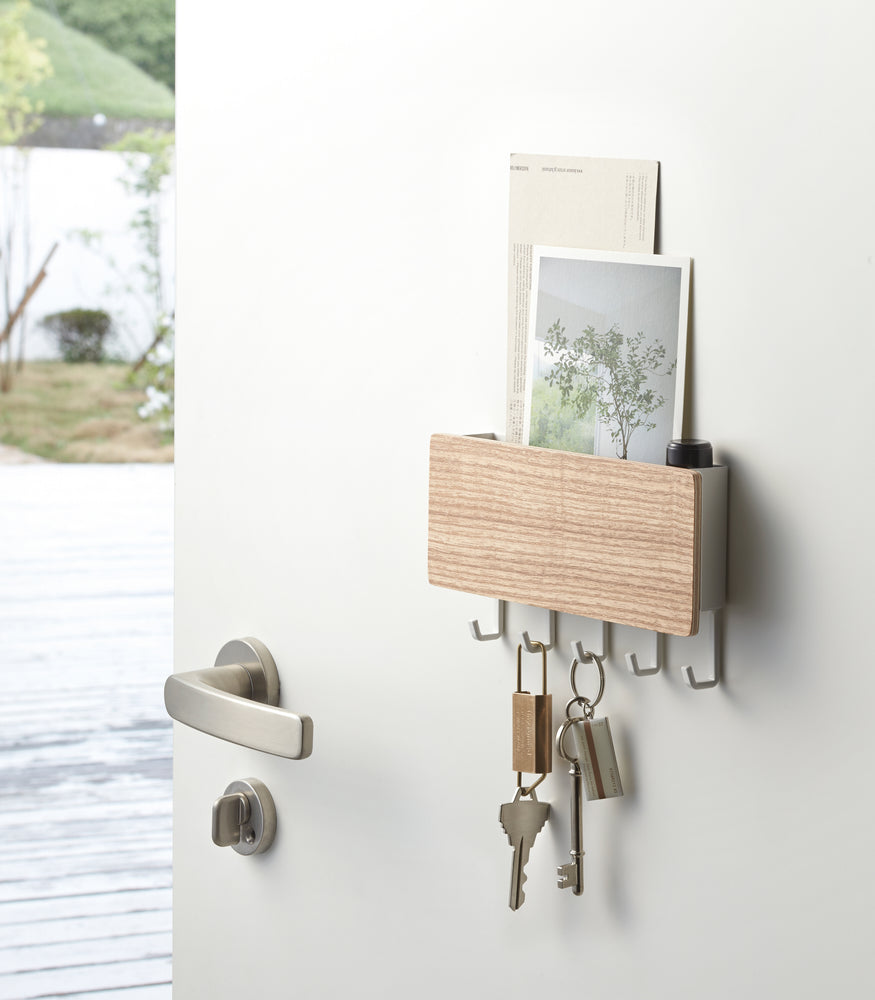 View 3 - Ash Magnetic Key Rack with Tray holding keys on door by Yamazaki Home.