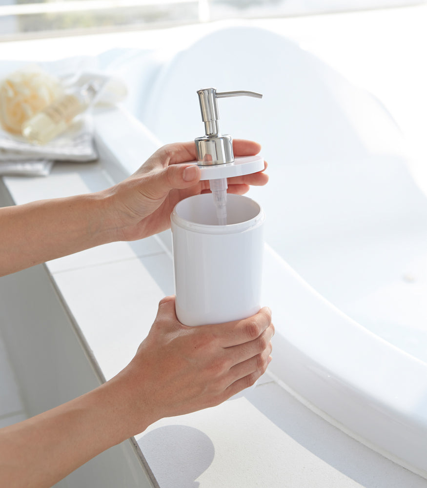 View 5 - White Shampoo Dispenser with top off in bathroom by Yamazaki Home.