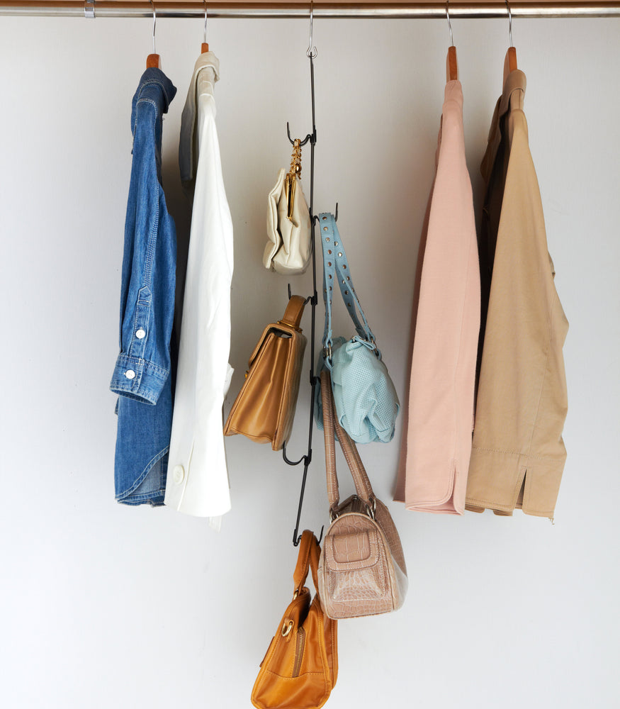 View 10 - Side view of black Chain Link Bag Hanger holding purses in closet by Yamazaki Home.
