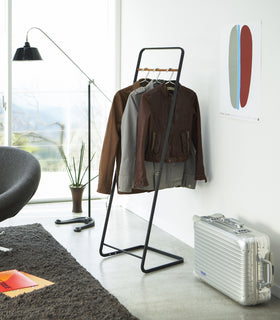 Black Clothes Rack holding jackets by Yamazaki Home. view 6